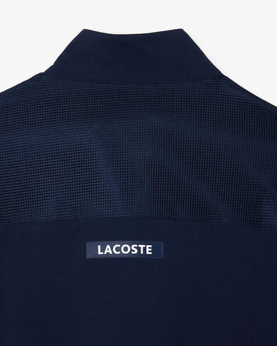 sportsuit lacoste azul marino con ribetes verdes y cierre completo