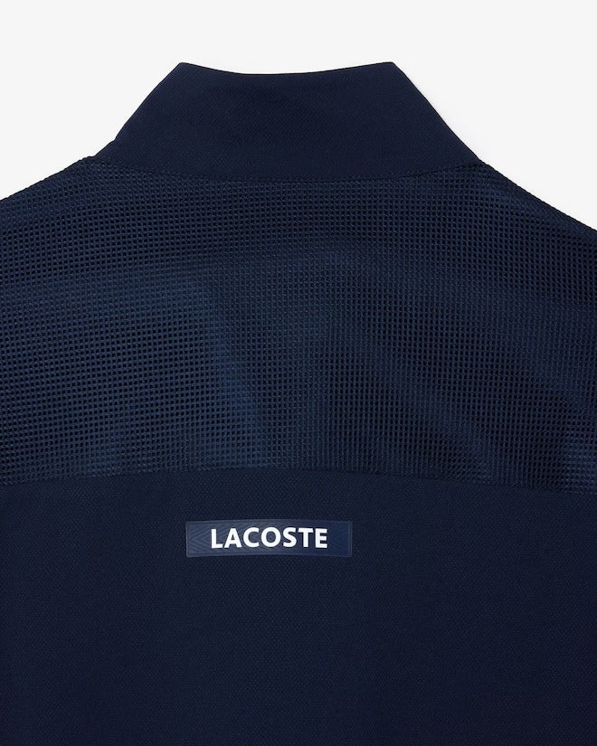 sportsuit lacoste azul marino con ribetes verdes y cierre completo